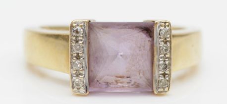 A 9ct gold princess cut amethyst dress ring, the amethyst flanked by diamonds, P, 3.8gm.