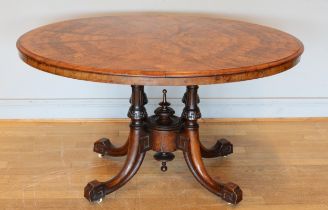 A late Victorian inlaid walnut oval loo table stamped Bros, raised on quadruple carved Greek Key and