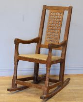 Peter 'Rabbitman' Heap of Wetwang, a 20th century carved oak open arm rocking chair, with pierced