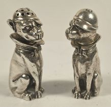 A pair of 925 silver novelty cast dog salt and pepper pots, modelled seated and each wearing a hat,