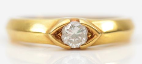 An 18k gold Diamond solitaire ring, the diamond weighing approximately .32ct within an elliptical