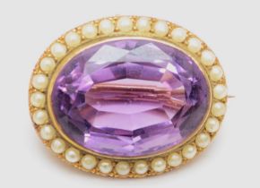 A Victorian unmarked gold amethyst and seed pearl oval brooch, stone 25 x 19mm, 11.1gm.