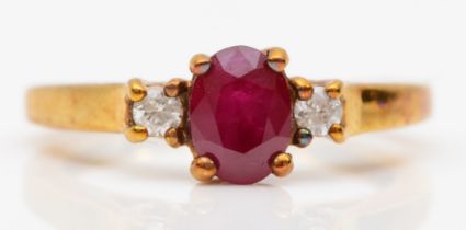 A 9ct gold ruby and brilliant cut diamond three stone ring, M-N, 2.4gm.