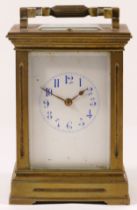 An early 20th century French brass and four glass corniche cased striking carriage clock, with swing