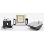 An Art Deco chrome plated desk set compring of a Smiths of London 8 day desk clock, the rotating