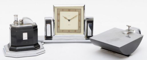 An Art Deco chrome plated desk set compring of a Smiths of London 8 day desk clock, the rotating