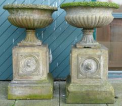 A pair 20th century concrete garden urns, raised on carved rectangular plinth, 100cm high