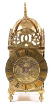 A late 19th century brass lantern clock, the chapter ring with black highlighted Roman numerals,