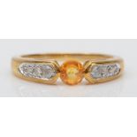 A 9ct gold yellow sapphire dress ring, with diamonds set to the shoulders, N-O, 2.6gm.
