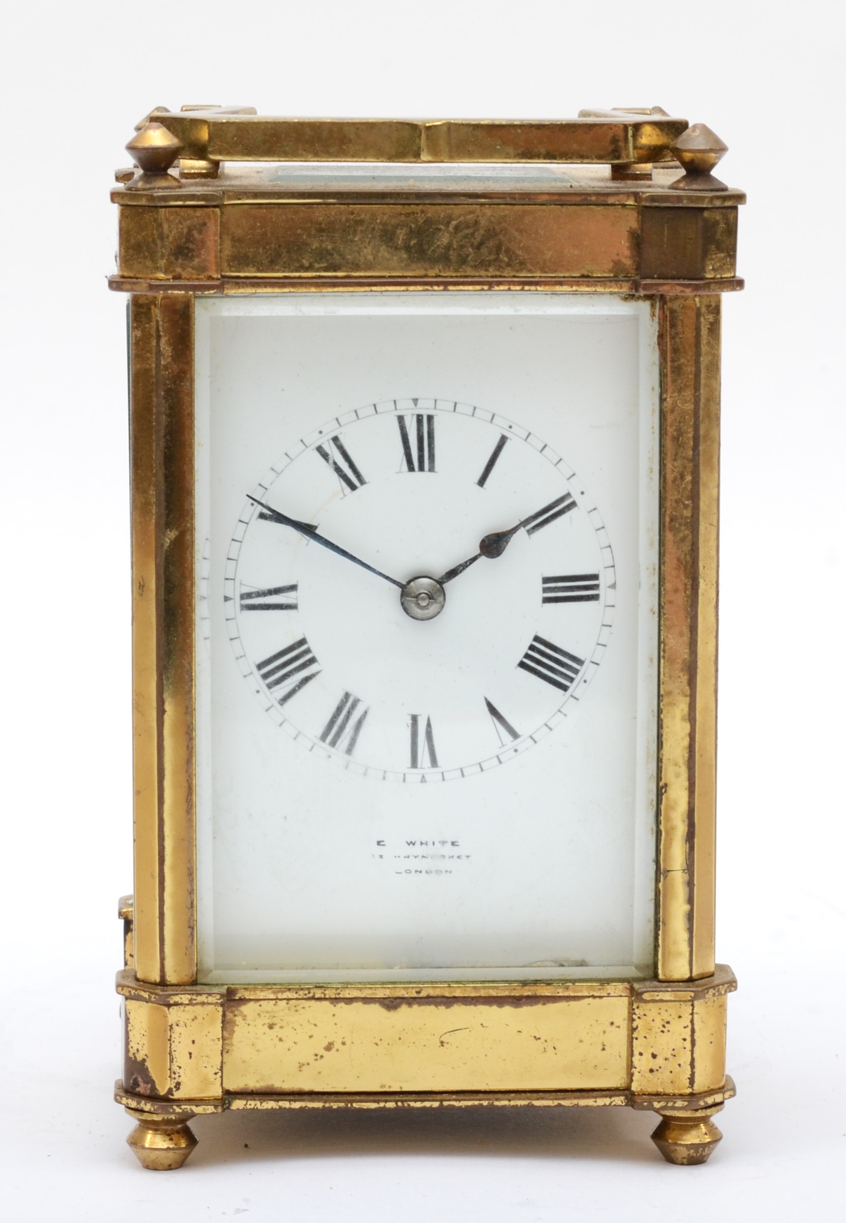 E. White 12 Haymarket London, a 20th century brass and glass corniche cased striking carriage clock,