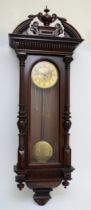 A 19th century carved mahogany cased Vienna style wall hanging clock/regulator, with broken arch