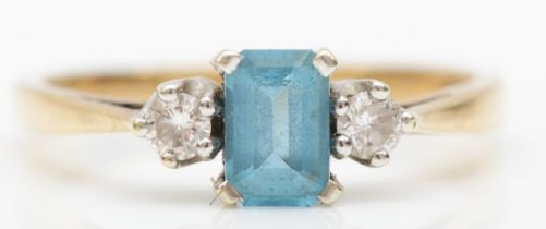 A 9ct gold blue topaz and diamond three stone dress ring, O, 2gm.