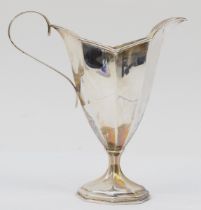 A Victorian silver octagonal panelled cream jug, Birmingham 1899, raised on a pedestal foot, 13cm,