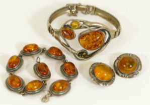 A Baltic amber and silver set hinged bangle, a similar bracelet and a pair of ear clips, 50gm