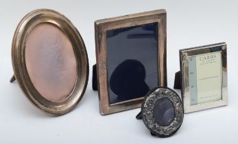 An oval silver photograph frame, Birmingham 1922, 17 x 13cm and three other silver frames