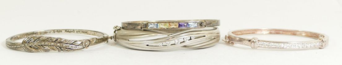 A silver hinged diamond set feather bangle, inscribed "Feathers appear when Angels are near", and