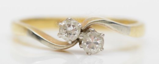 An 18ct gold and platinum set brilliant cut two stone diamond ring, O, 2.5gm.