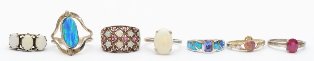 Six silver set opal rings, L - R, 22gm