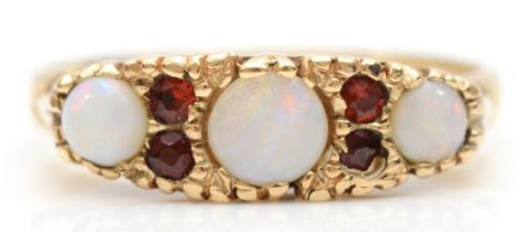 A 9ct gold three stone opal and garnet dress ring, L, 3.2gm.