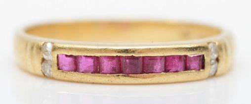 A 14k gold channel set ruby dress ring, with four eight cut diamonds set to the shoulders, M, 2.3gm.