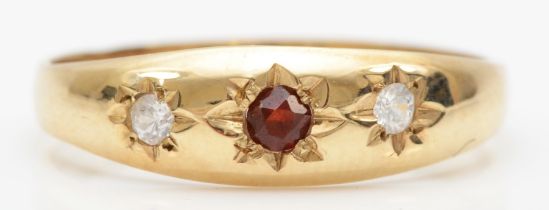 A 9ct gold three stone garnet and cubic zirconia dress ring, P, 1.6gm