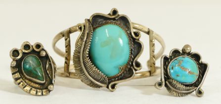 An unmarked Native American silver and turquoise bangle and two silver and turquoise rings, 48gm