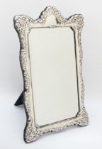 A silver framed easel mirror, Sheffield 1991, with embossed decoration, 38 x 24cm