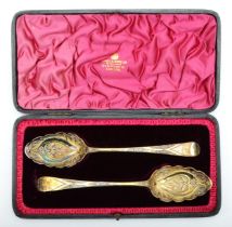 A pair of silver gilt berry spoons, London 1978 and 1810, 22.5cm, 117gm, cased