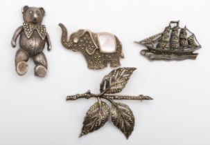 A silver and marcasite schooner brooch and three other brooches, 59gm