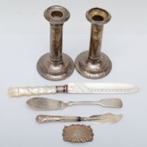 A Victorian silver and mother of pearl handled bread knife, a silver Sherry ladle, two knives and