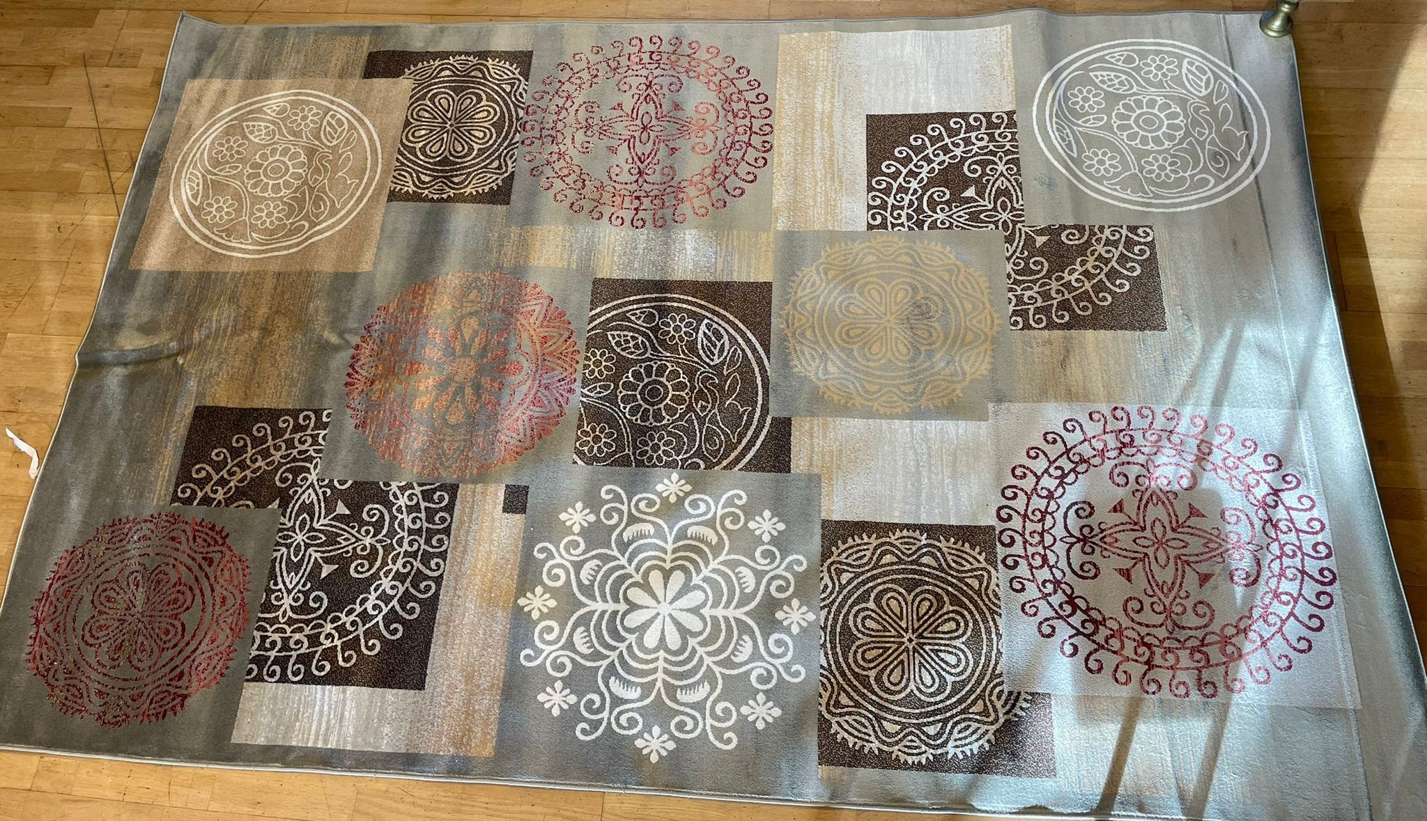 A contemporary brown background silk/wool mix rug embroidered with roundels of Eastern style