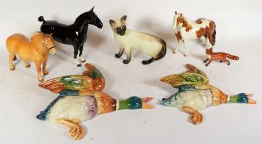 A collection of Beswick figures, to include three horses, a siamese cat, a fox and two wall mounting