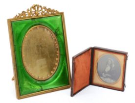 A daguerreotype of a young lady, case and a brass photograph frame