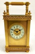 An early 20th century French gilt brass carriage clock, having porcelain dial with Arabic