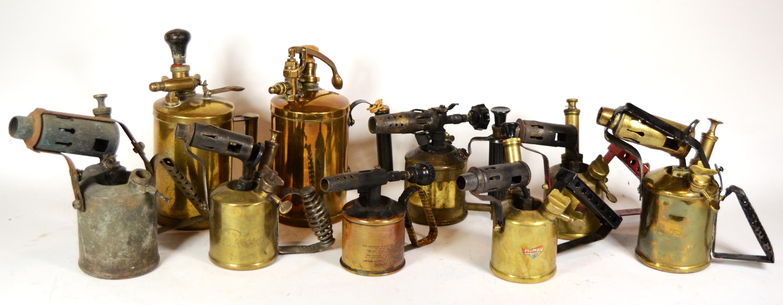 A collection of early 20th century brass blow torches.