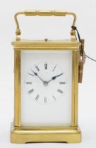 A late 19th century brass striking carriage clock, the movement striking the half and hour, key,