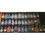 A collection of metal and enamel car key fobs