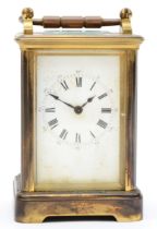A brass striking carriage clock, the unsigned movement striking the half and hours, spares or