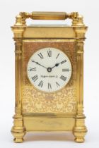 Mappin & Webb, a gilt brass carriage time piece, with ornate front panel and fluted columns, 13.5cm