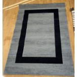 A contemporary brown woolen mix abstract pattern rug, 240x159cm, together with grey and black