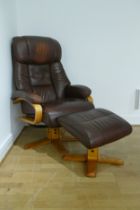 A brown leather reclining arm chair with matching foot stool.