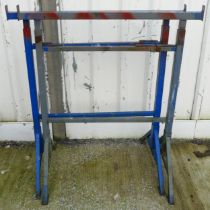 A pair of builders steel trestles, adjustable height and and width, height 11cm and width 82cm.