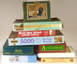 A collection of jigsaw puzzles, with other board games included.