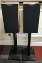 A pair of Cabasse enc1063 speakers with floor stands