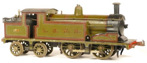 Bing for Bassett Lowke, a clockwork tin plate gauge 1 L.S.W.R 109 locomotive, with brown edged green