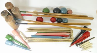 An early 20th century cased croquet set, with hickory shaft mallets, turned painted wooden balls,