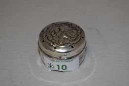 An Edwardian silver baby powder caster, of cylindrical form, the cover pierced and embossed with a