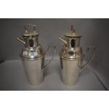 Two iconic 1930s silver plated Asprey of London milk churn shaped cocktail shakers having handle
