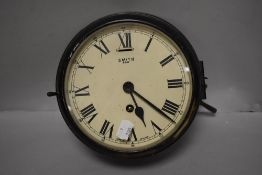 An early 20th century painted brass Smiths factory clock, having 8 day movement, with glass door and