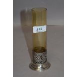 A silver and glass stem vase having cylindrical amber glass vase in a moulded silver base,